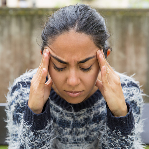 Group therapy session for complex trauma with 3 men and 1 woman and female black therapist.