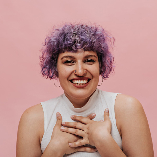 Joyful neurodivergent woman with purple hair.