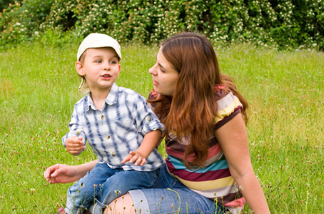 Mom playing with young boy with autism